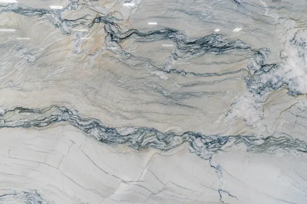 Marbled stone surface with flowing gray, beige, and white veining.