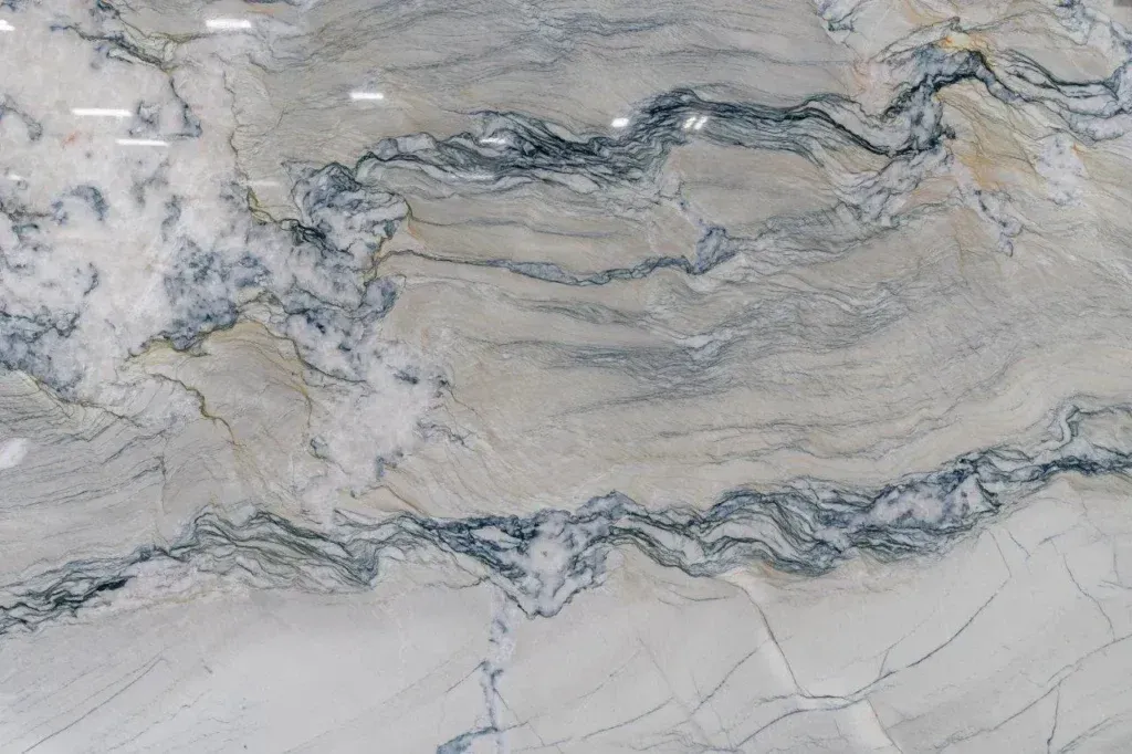 Abstract gray and beige marble-like stone with wavy blue-gray veins