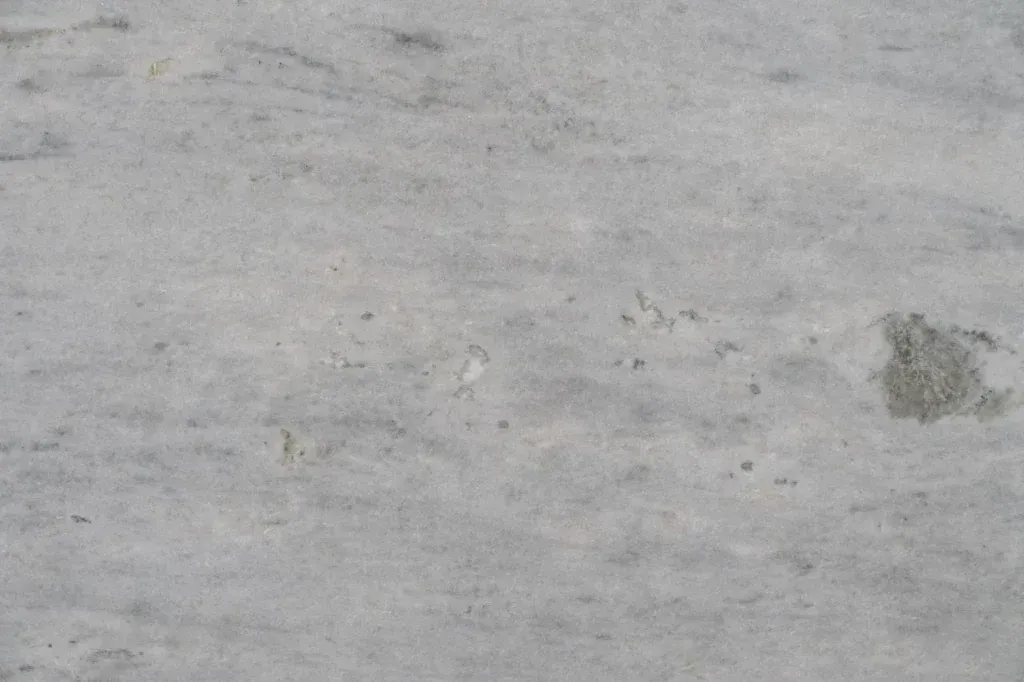 Gray concrete surface with a small dark stain on the right side.