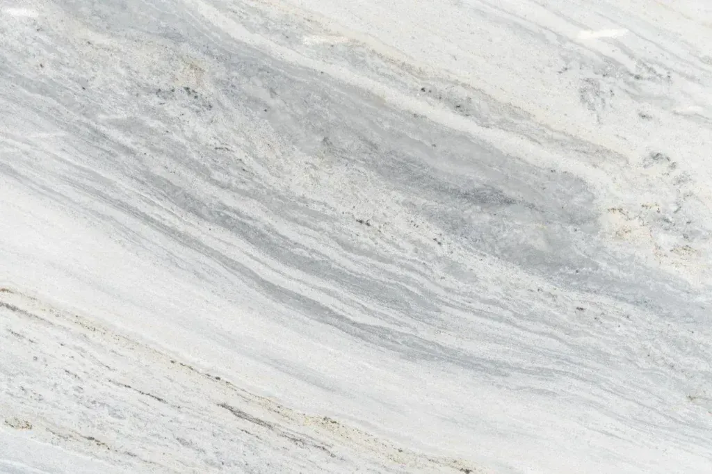 Light gray and white marbled stone surface with subtle diagonal veining