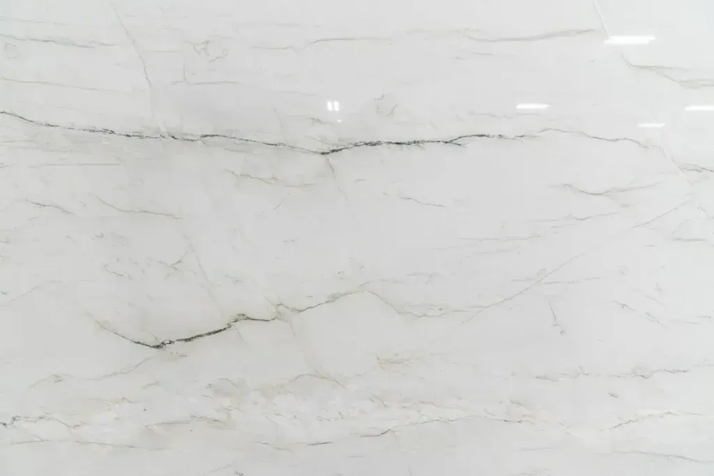 White marble surface with subtle gray veining and a polished finish