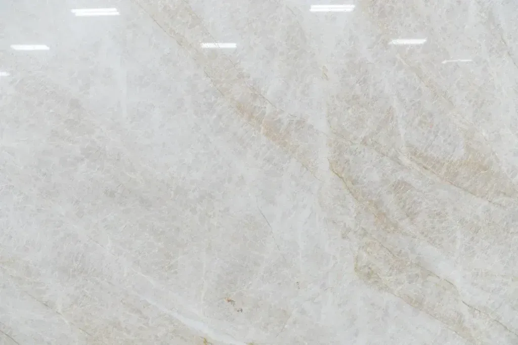 Light gray marble surface with subtle beige veining and glossy reflections