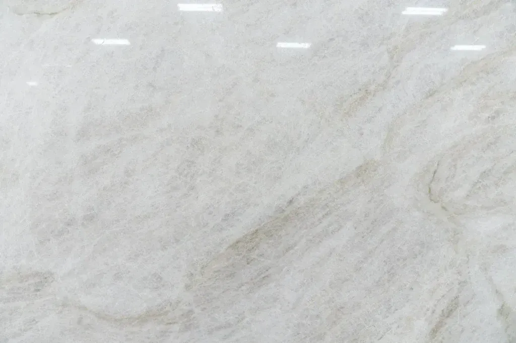 Light gray marble-like textured surface with faint diagonal veining and small white marks near the top