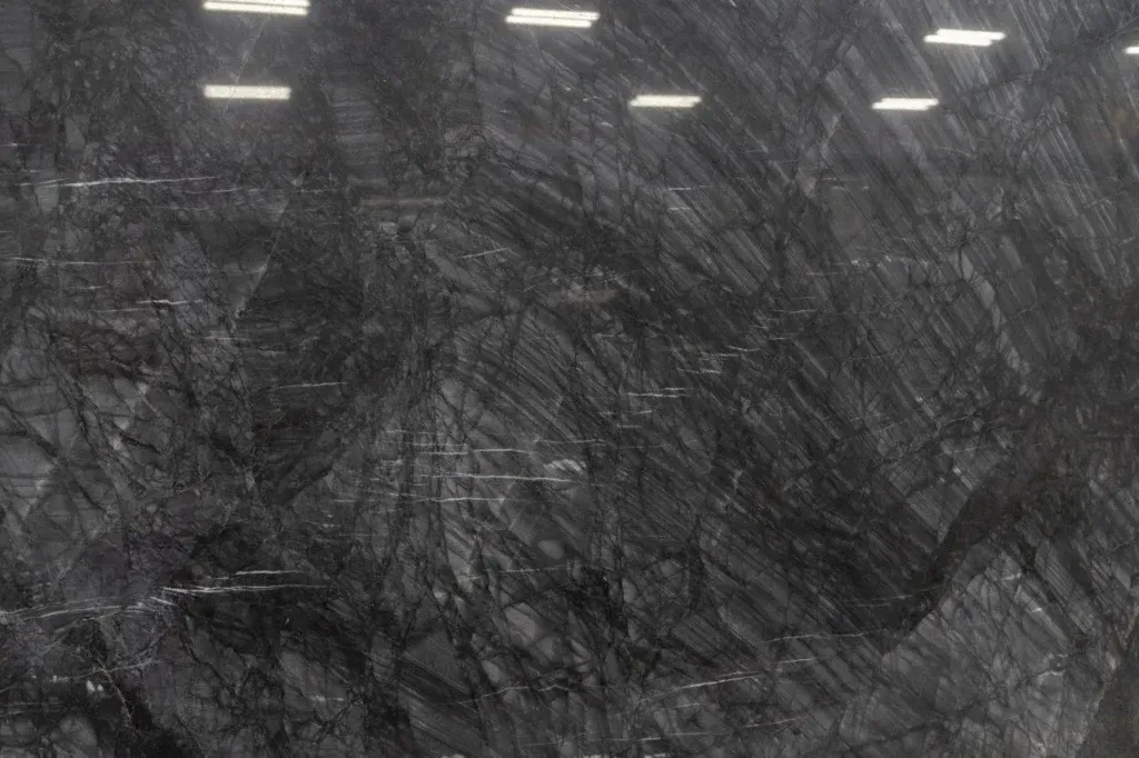 Dark gray abstract textured surface with a few white streaks at the top