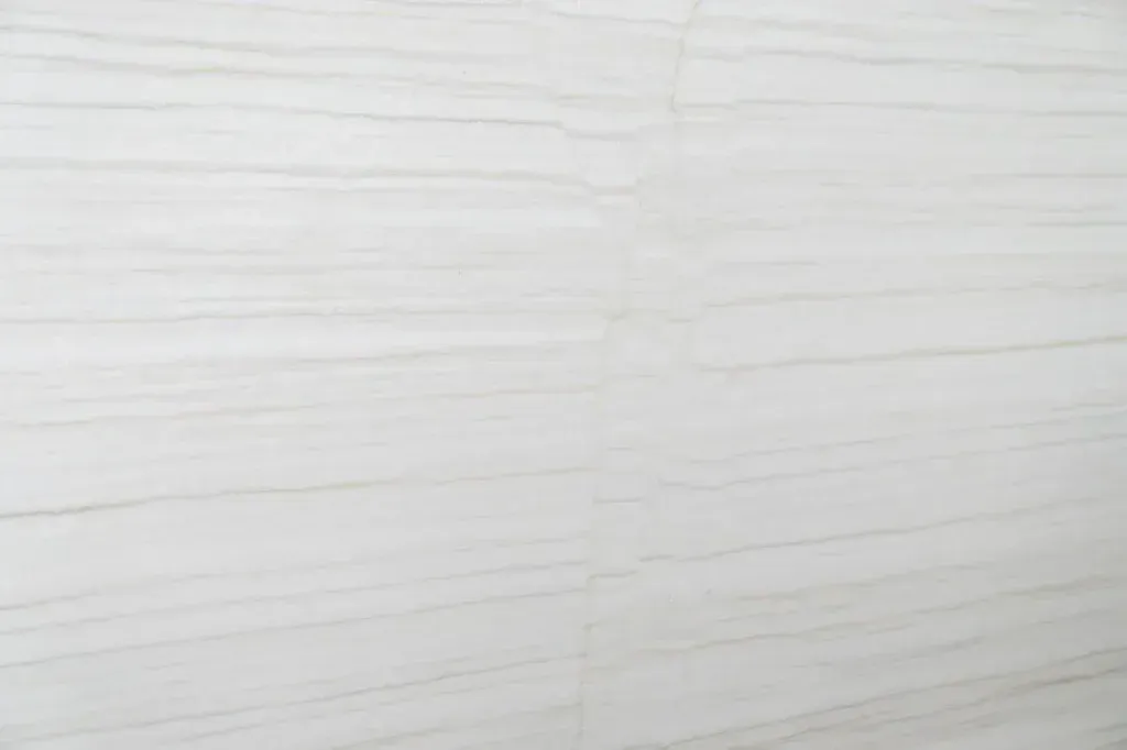 Close-up of a light gray textured surface with faint horizontal lines
