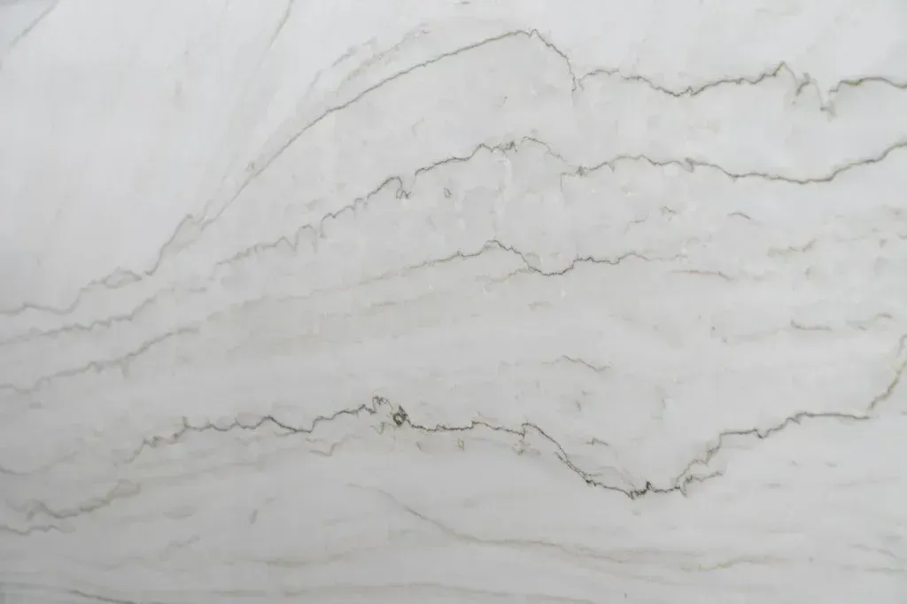 White marble surface with subtle gray veining and a polished finish