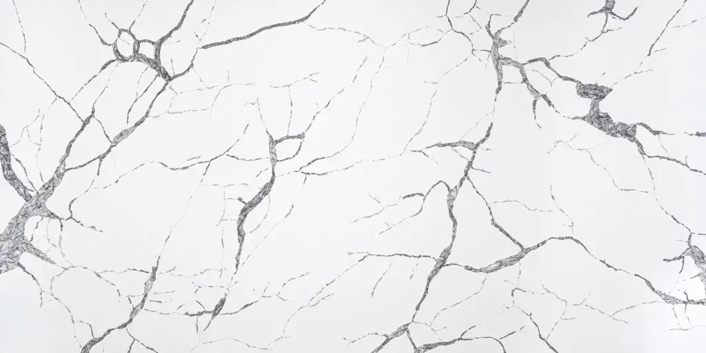White marble surface with thin gray veining and subtle cracks