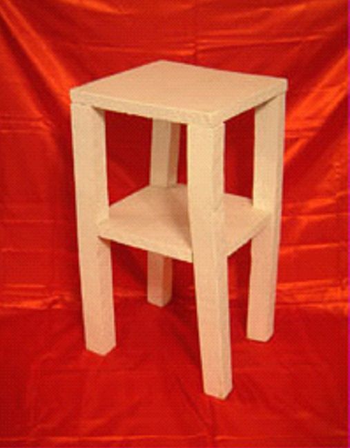 A small white table with a shelf sits on a red cloth