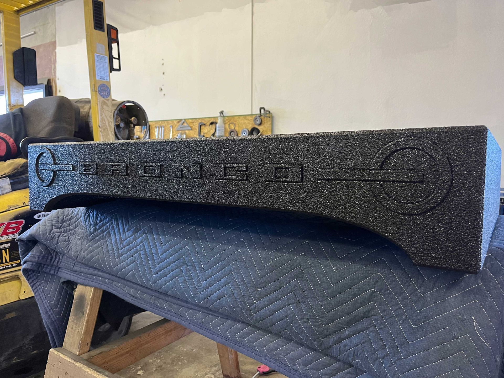 A black, speckled speaker enclosure with the word 