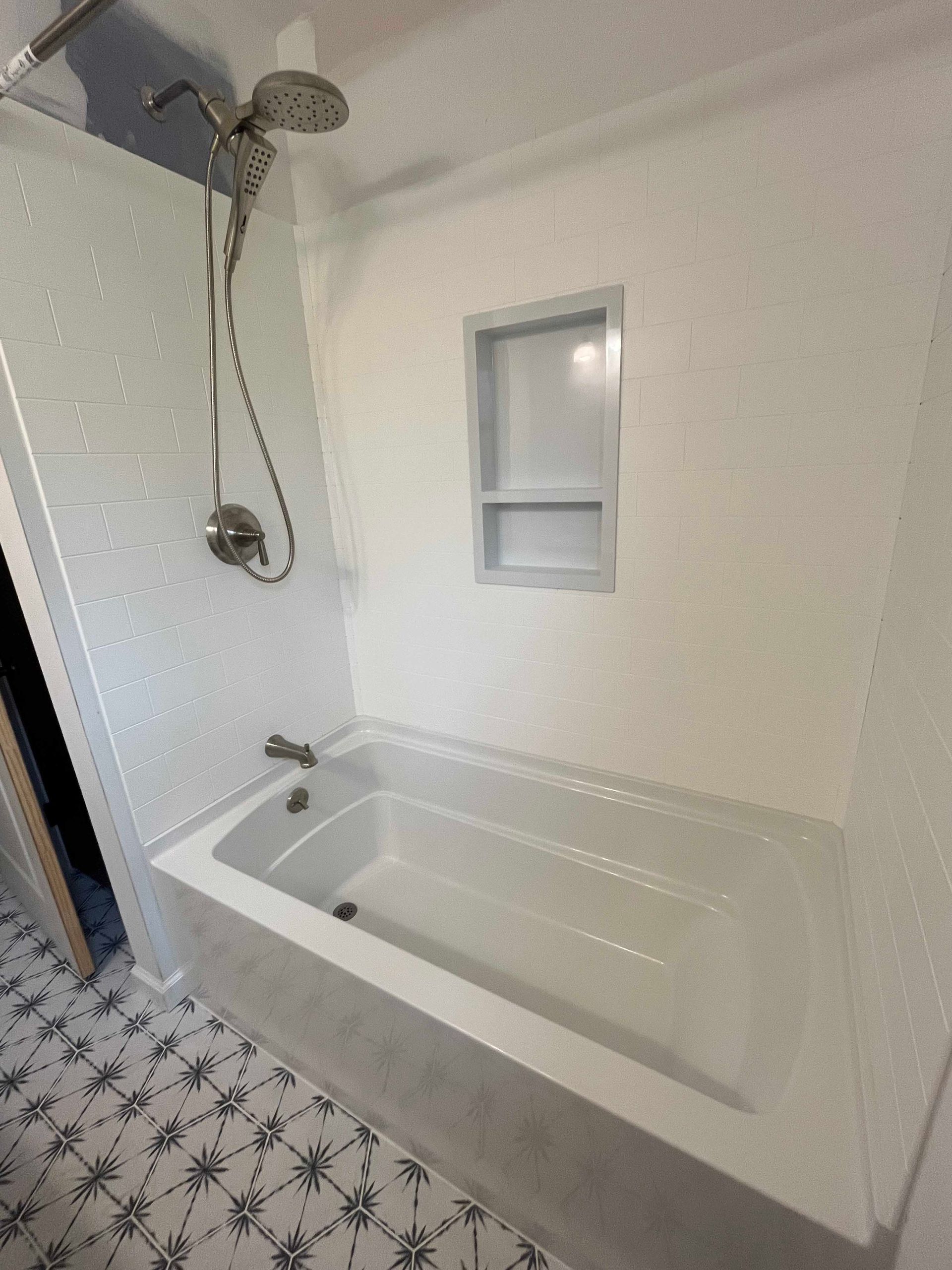 A bathroom with a bathtub and a shower.
