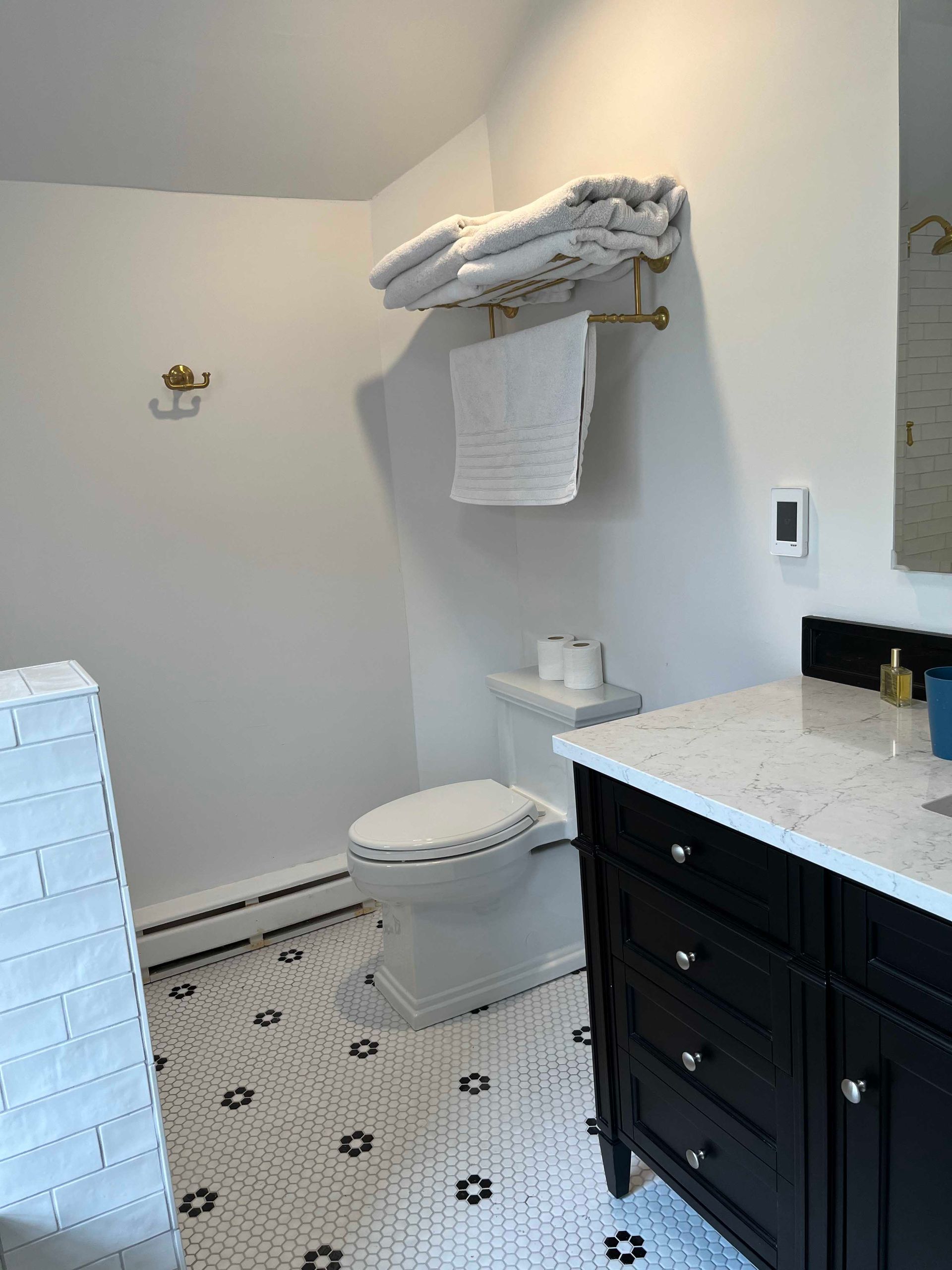 A bathroom with a toilet , sink , and shower.