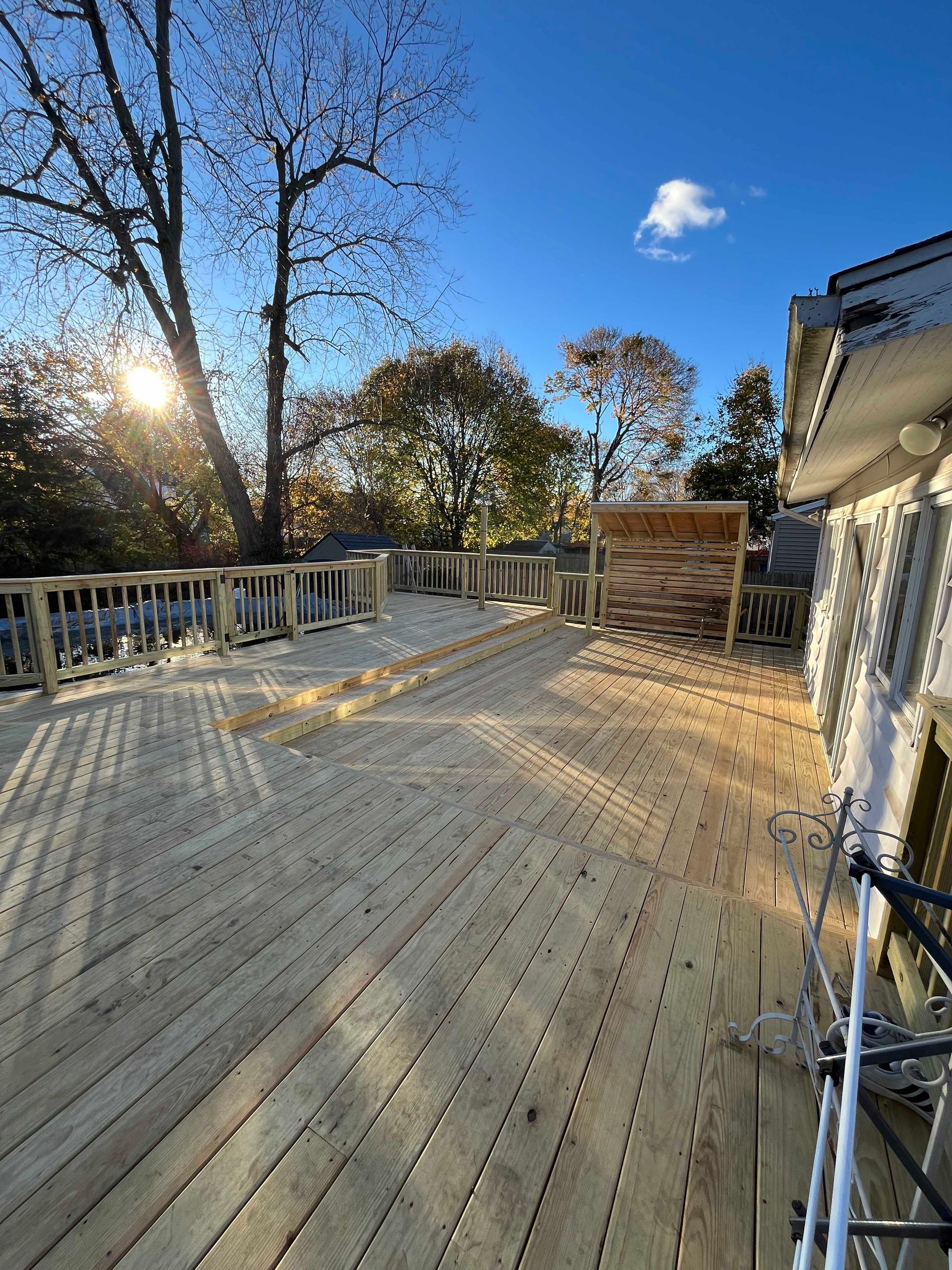 A wooden deck is being built on the side of a house.