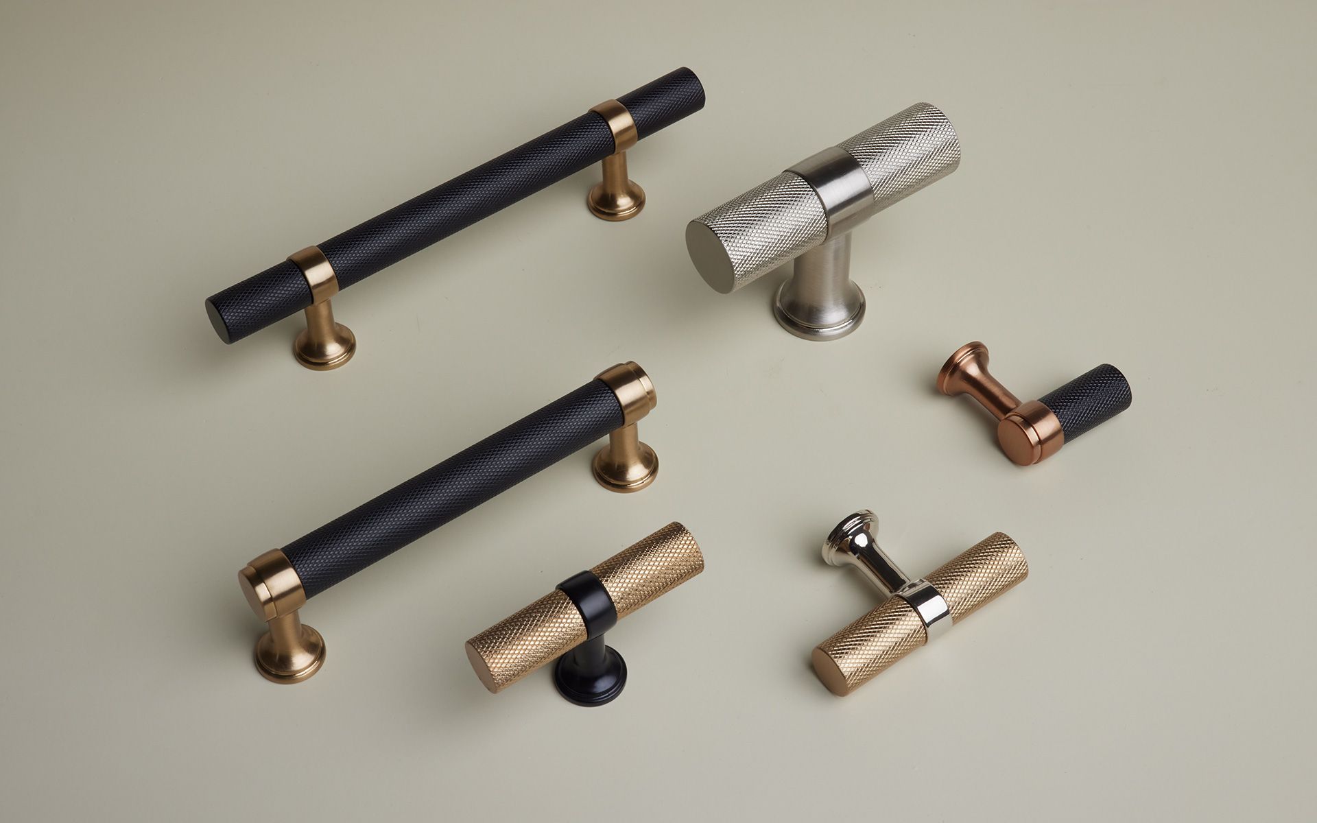 A group of cabinet handles are sitting on a table.