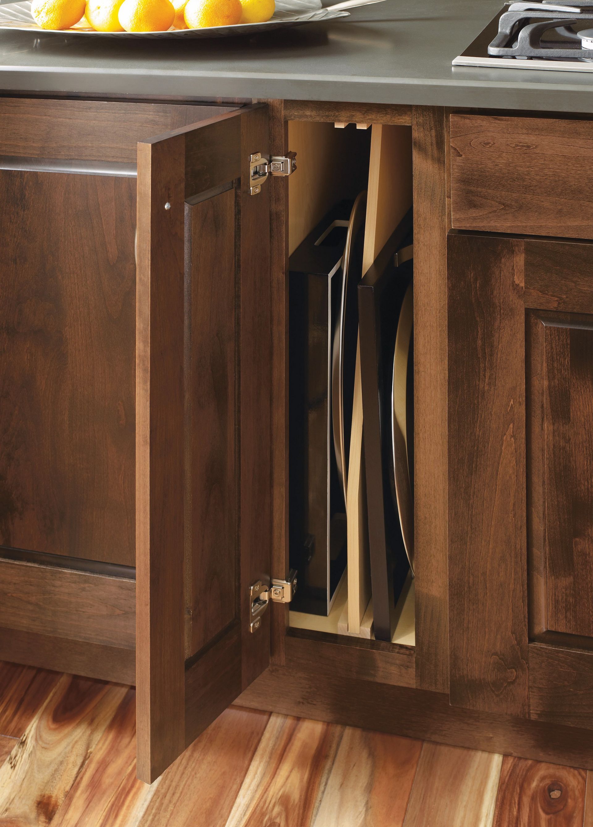 A wooden cabinet with a tray of lemons on top of it