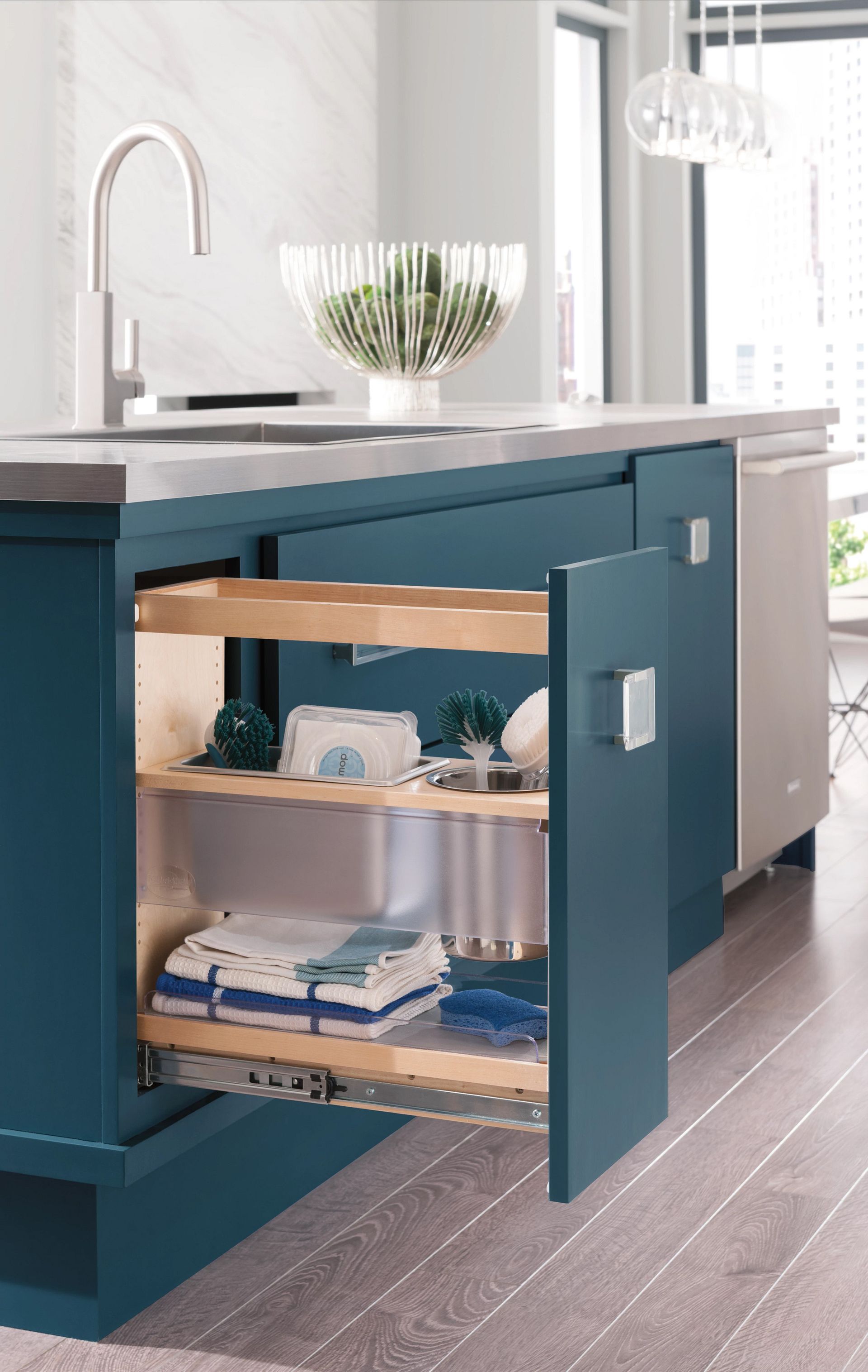 A kitchen sink with a pull out shelf underneath it.