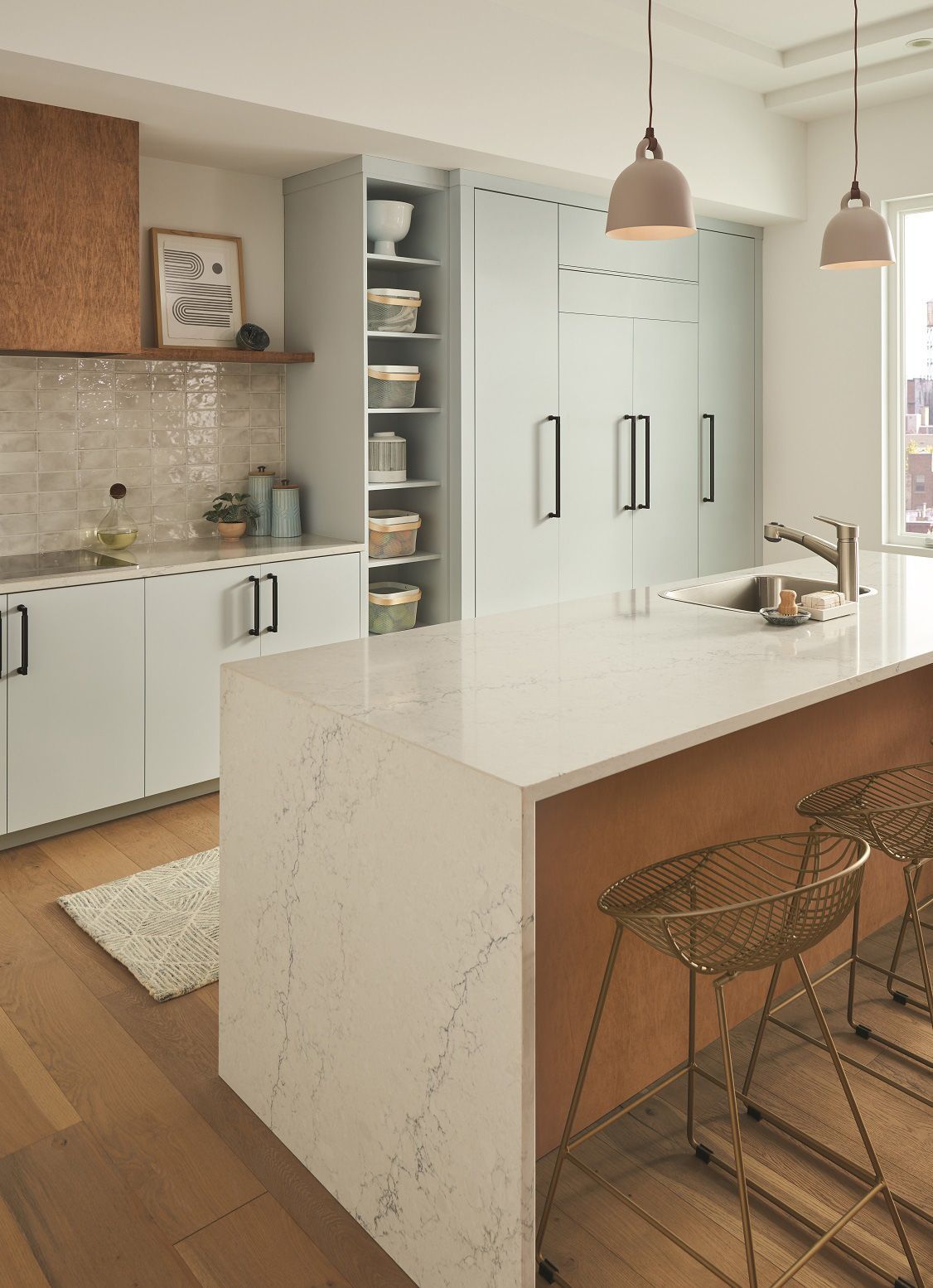 A kitchen with a large island and stools