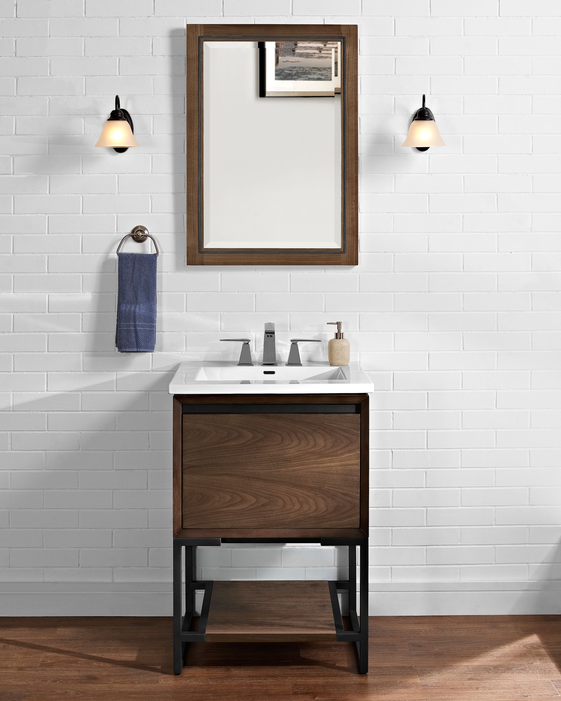 A bathroom with a sink , mirror and towel rack.