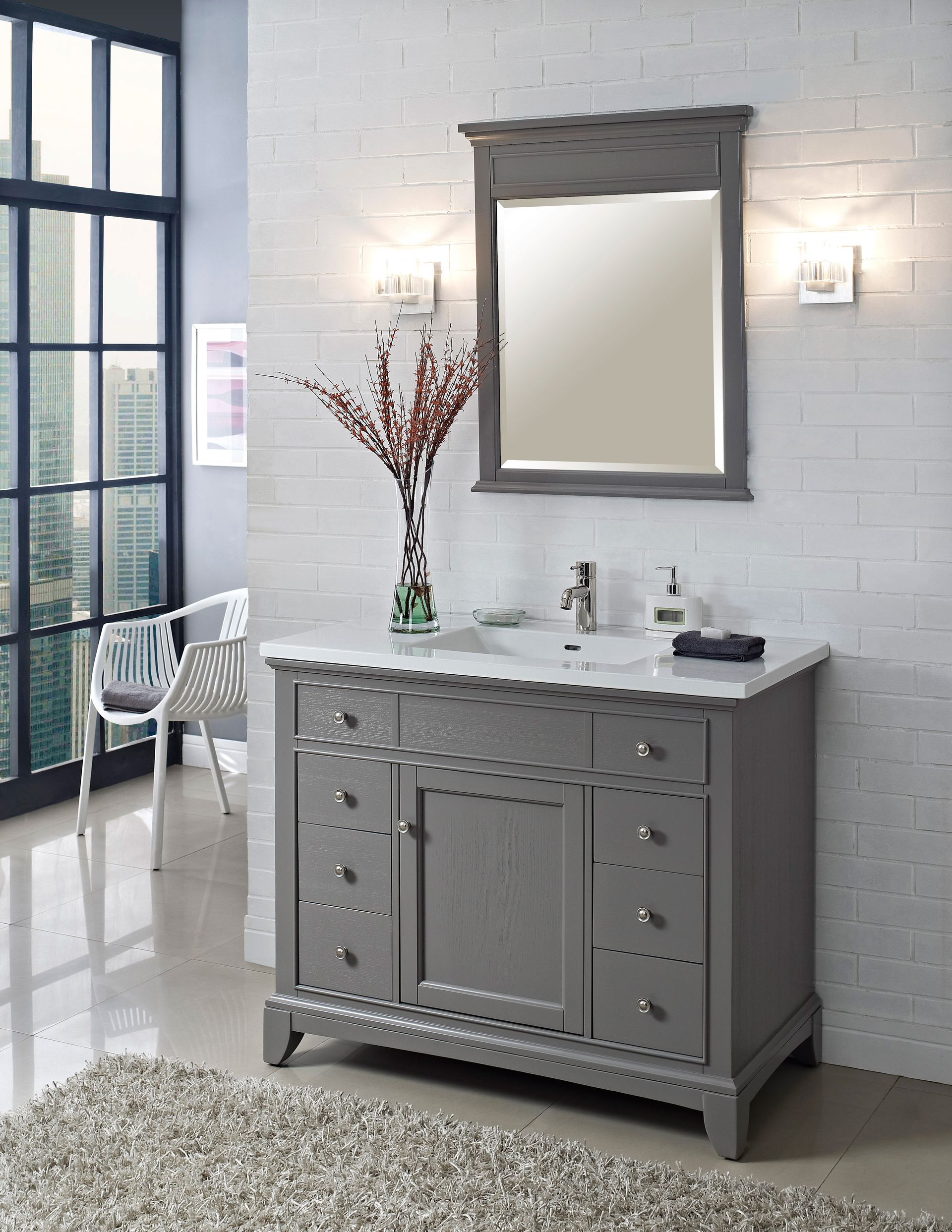 A bathroom with a gray vanity and a mirror