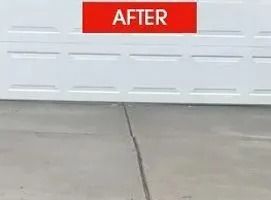 White garage door with concrete driveway; red 