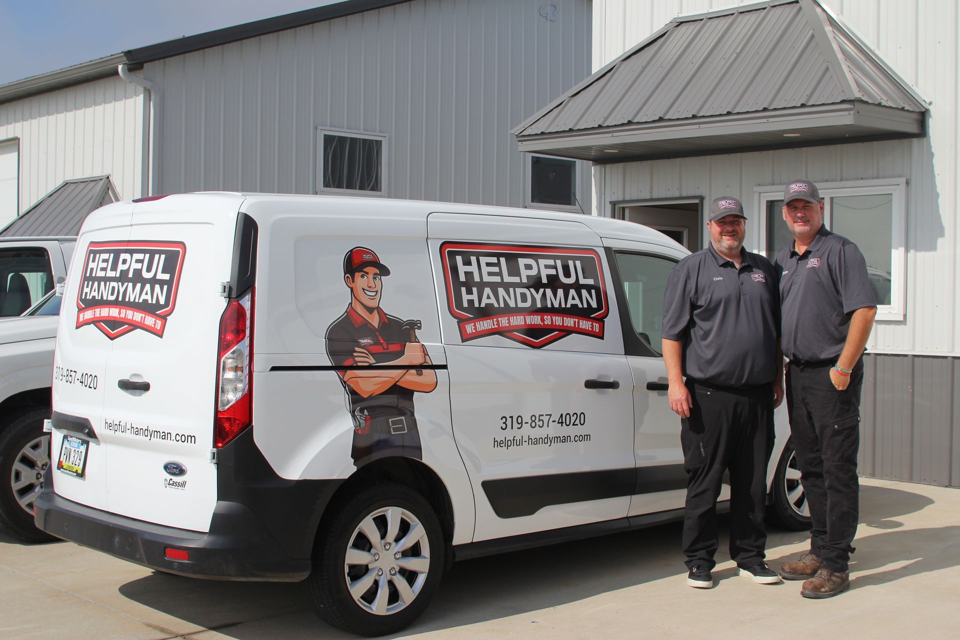 Two men stand beside a van with 