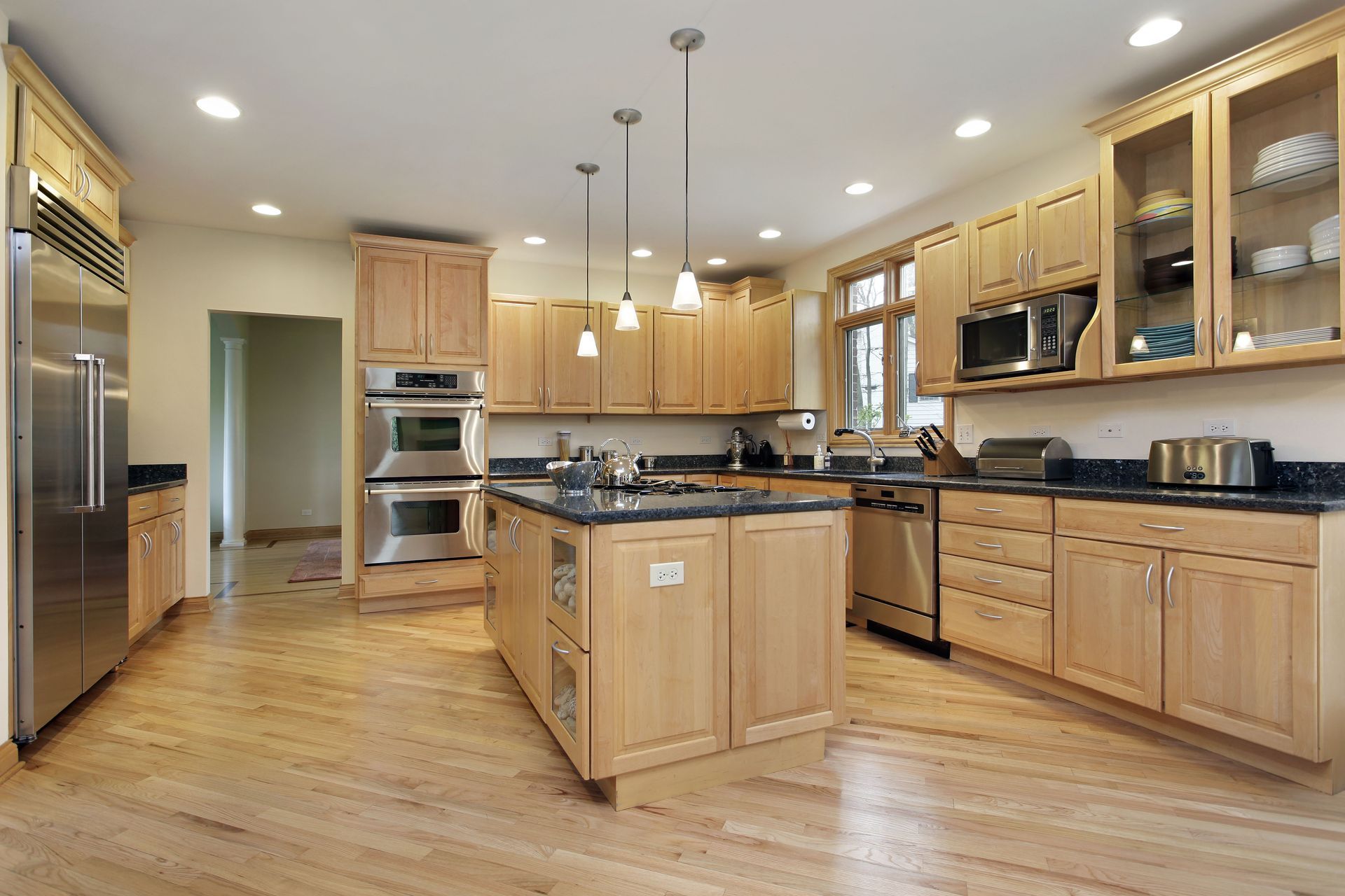 A large kitchen with wooden cabinets and stainless steel appliances
