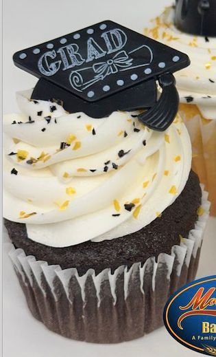 Chocolate cupcake with white frosting and a black GRAD topper, sprinkled with yellow confetti