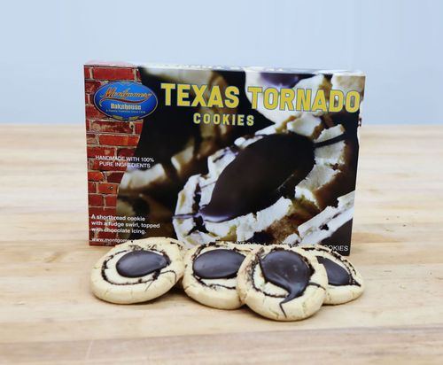 Texas Tornado cookies in front of a box on a wooden surface.