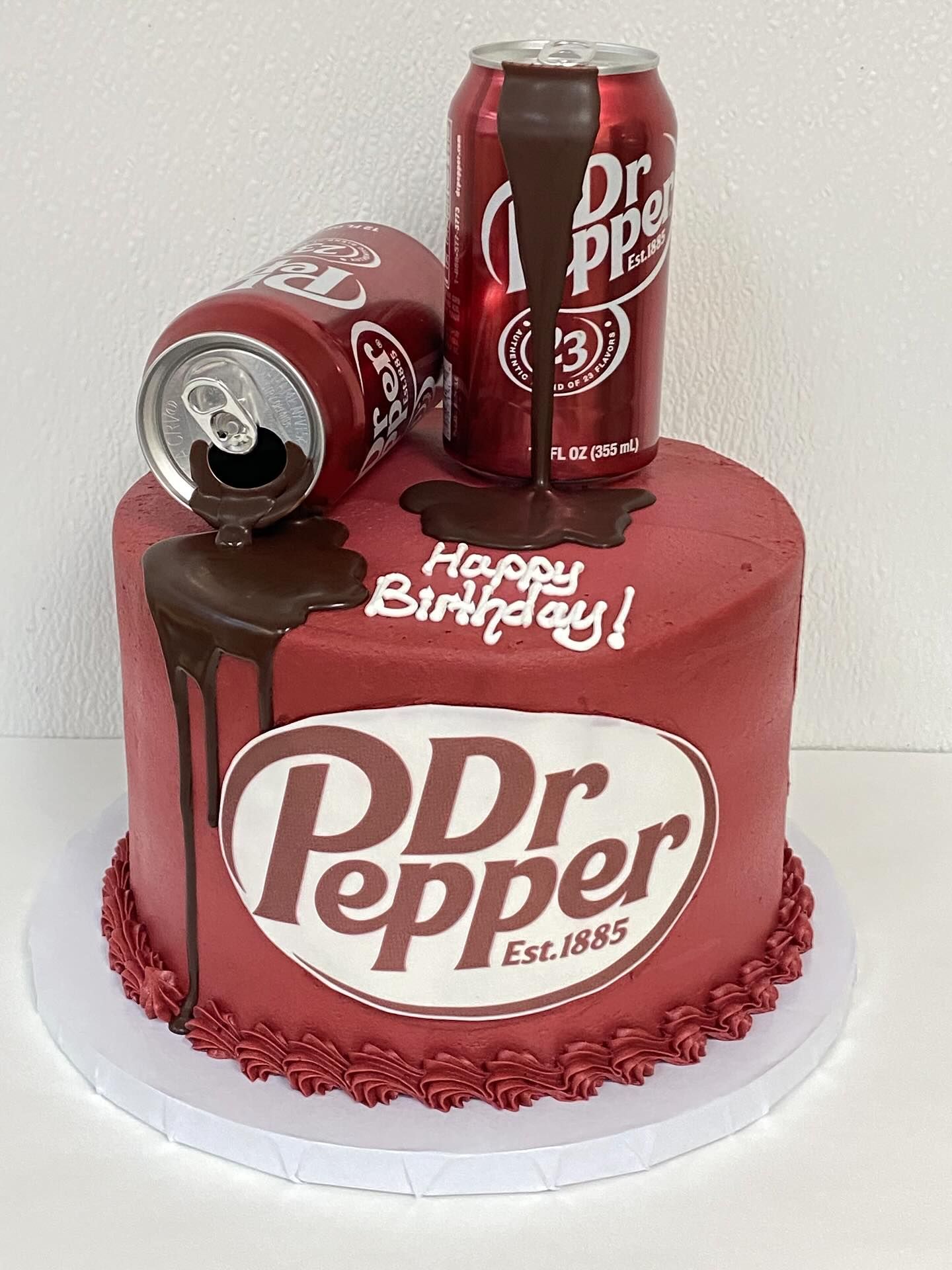 Dr Pepper-themed birthday cake with soda cans, chocolate drips, and logo.