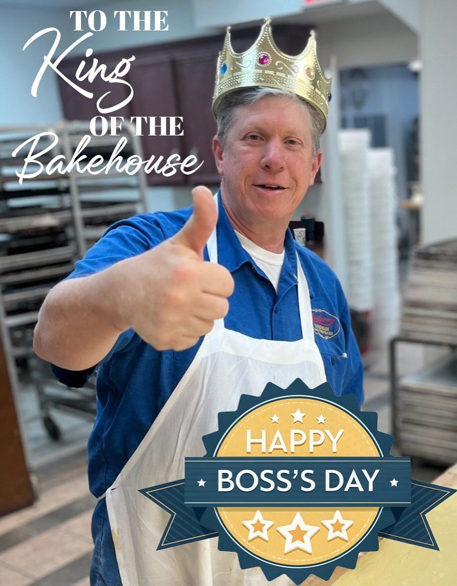 Man in baker's attire wearing a crown, giving a thumbs up.