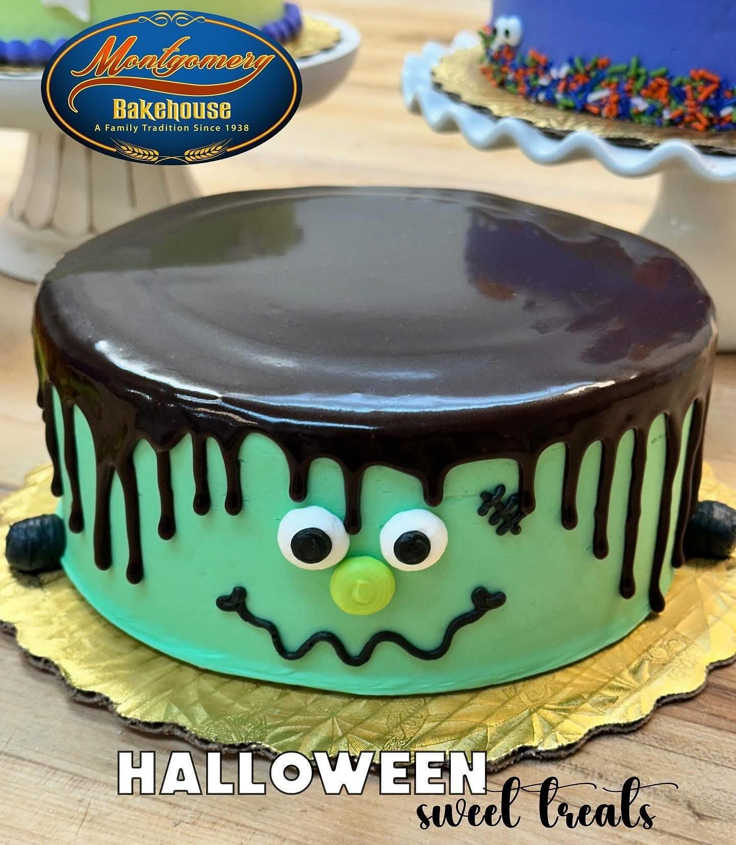 Halloween cake decorated as Frankenstein's monster with green frosting and dripping chocolate, on a gold plate.