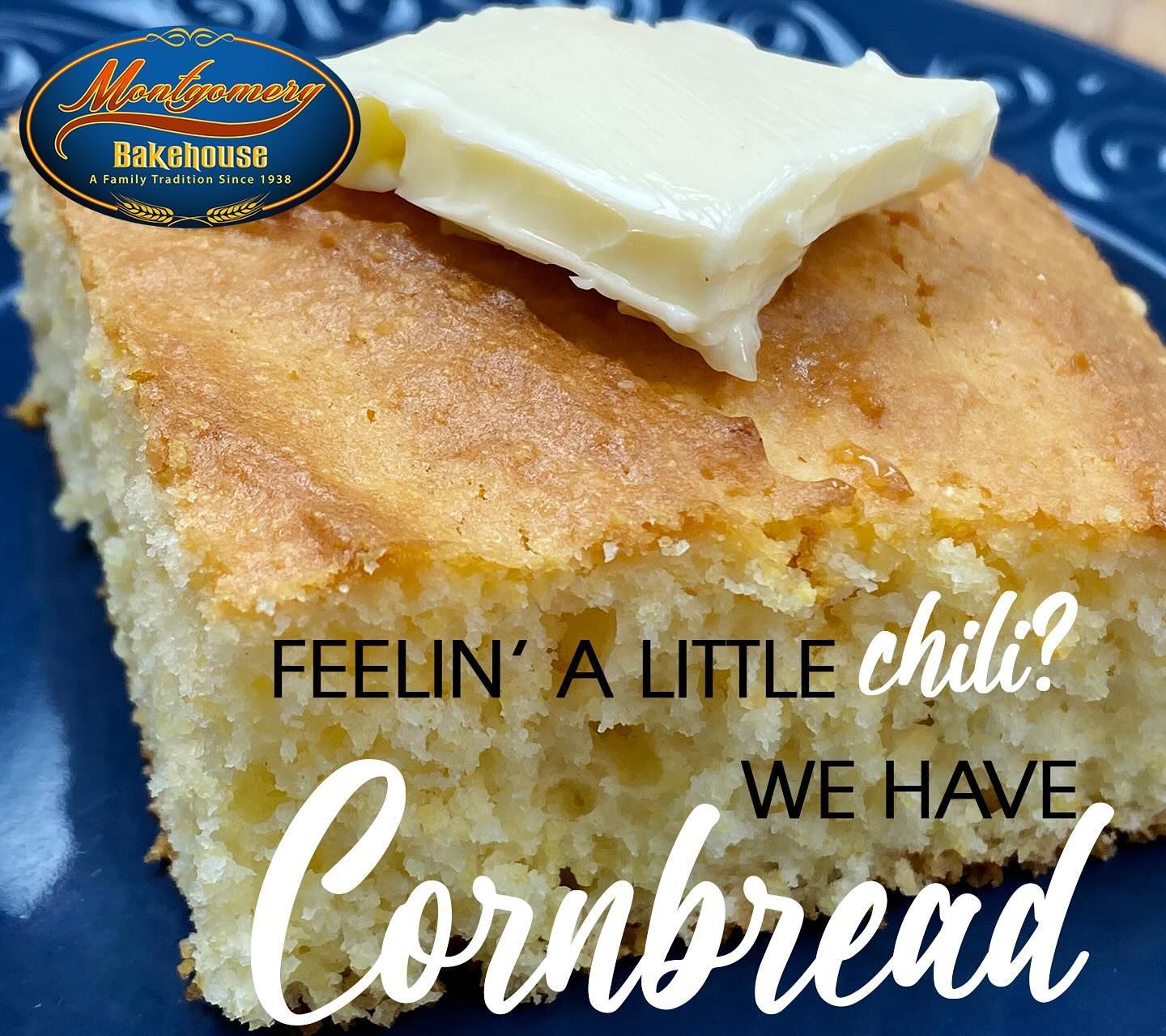 Slice of cornbread with butter, on a blue plate.