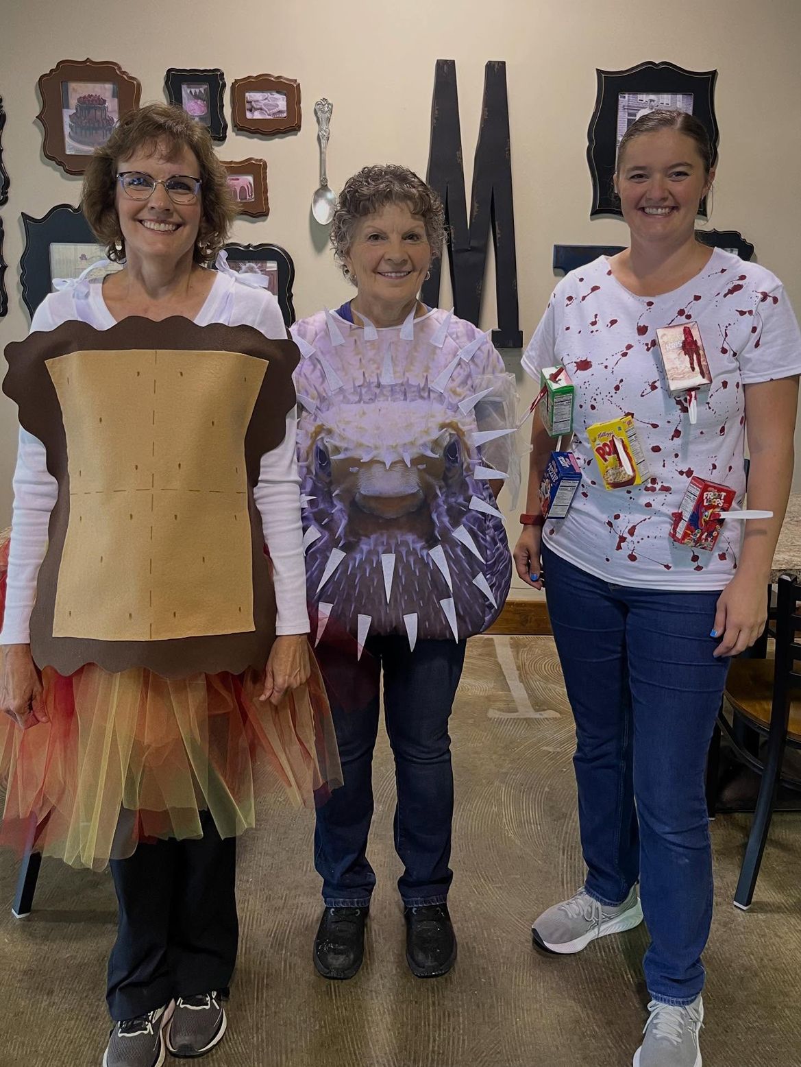 Three people in homemade costumes: sandwich, spider, and snacks.
