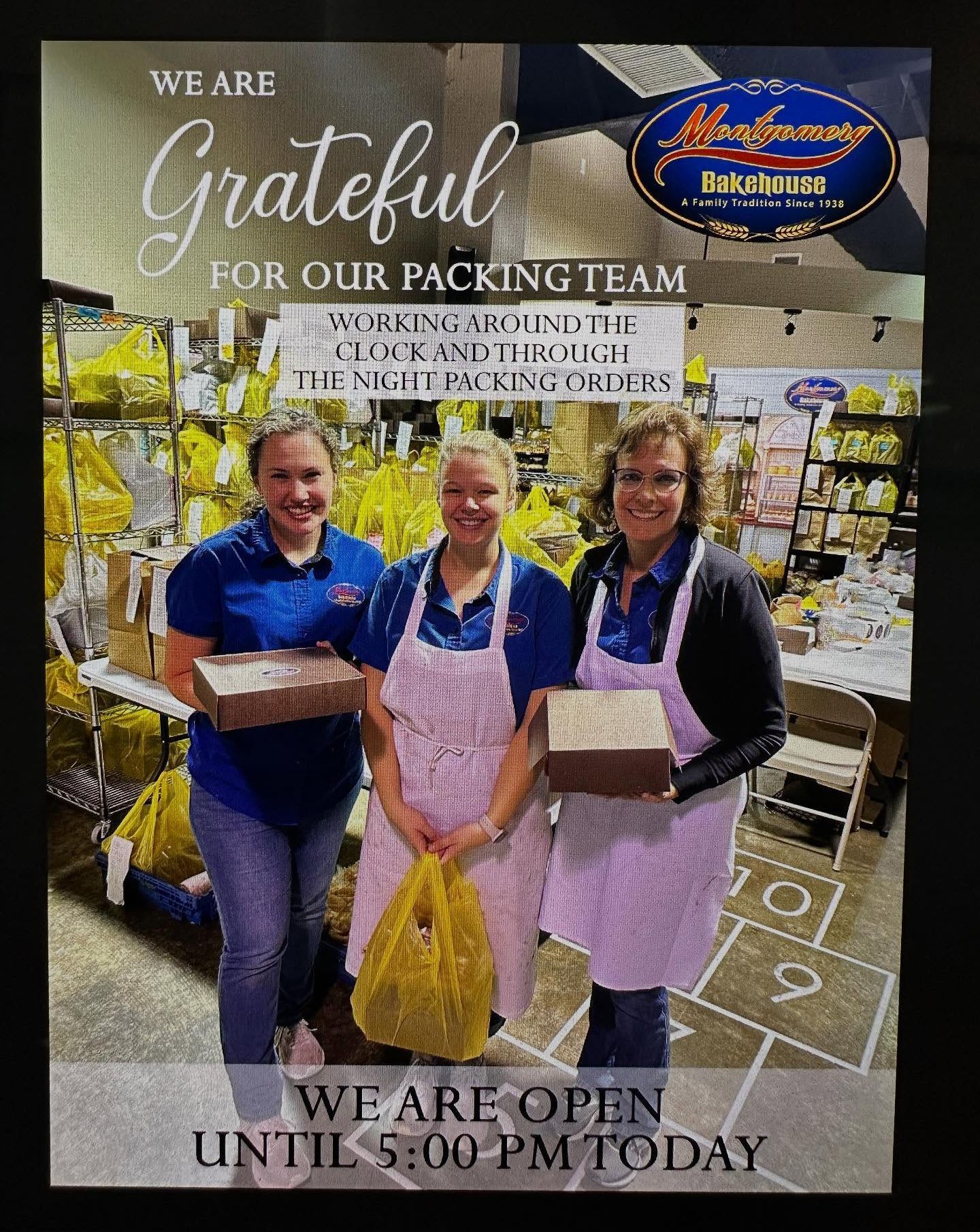 Three women holding boxes/bags, working in a packing area.