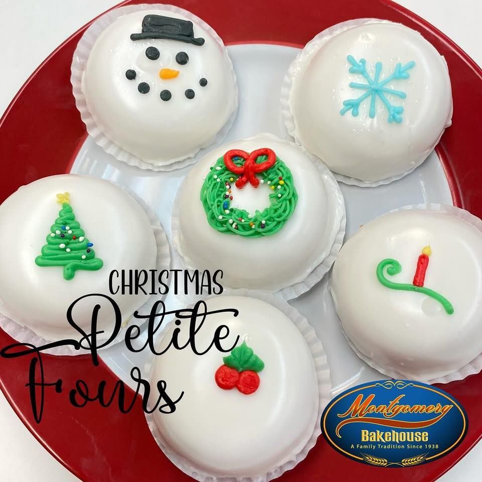 Christmas petite fours on a red plate, with snowman, snowflake, wreath, and other holiday decorations.