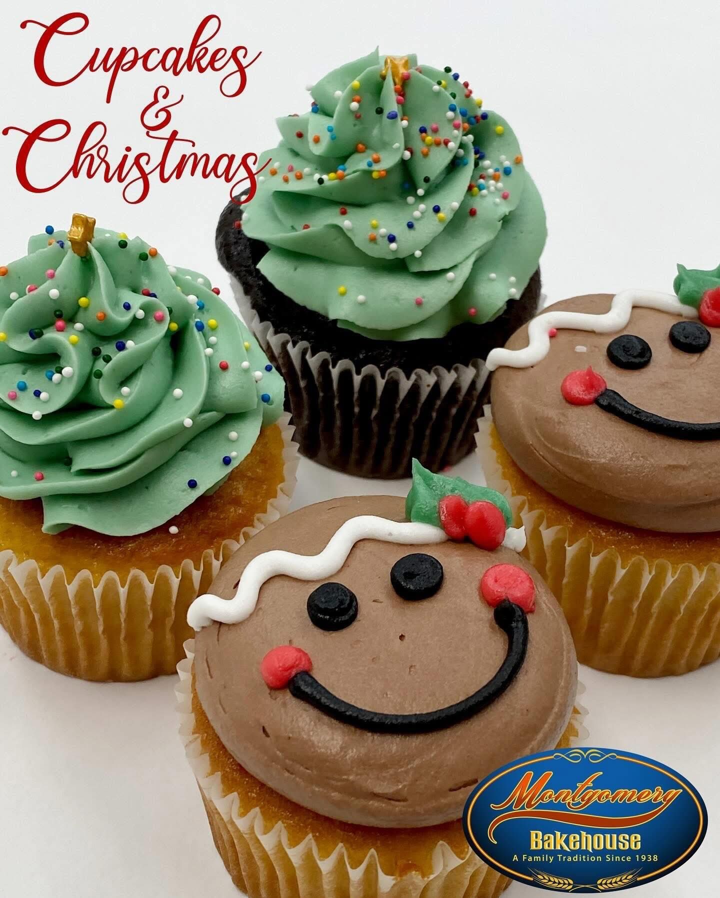 Four Christmas cupcakes: two with green frosting tree designs, two with gingerbread man faces.