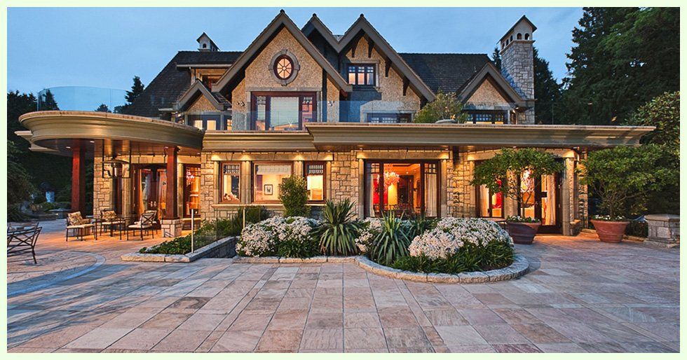 a beautiful home with stone walkways and patios
