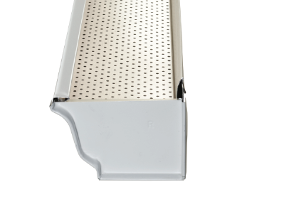 Close-up of a perforated white plastic tray corner with a gray molded edge