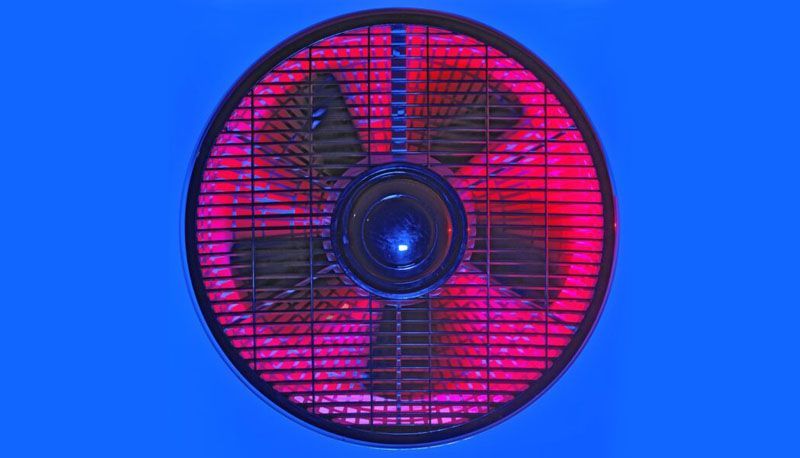 A close-up of a red fan on a blue background