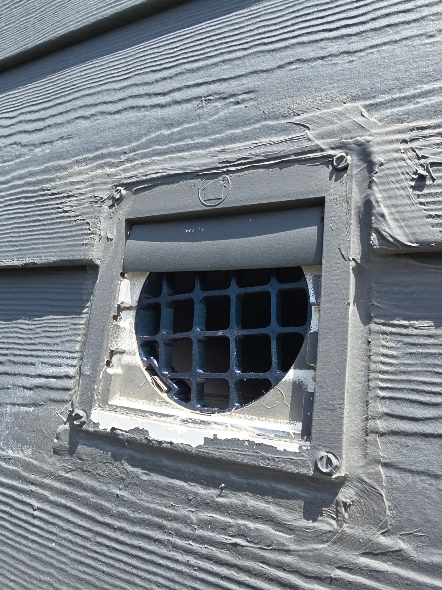 There is a hole in the side of a building that looks like a window