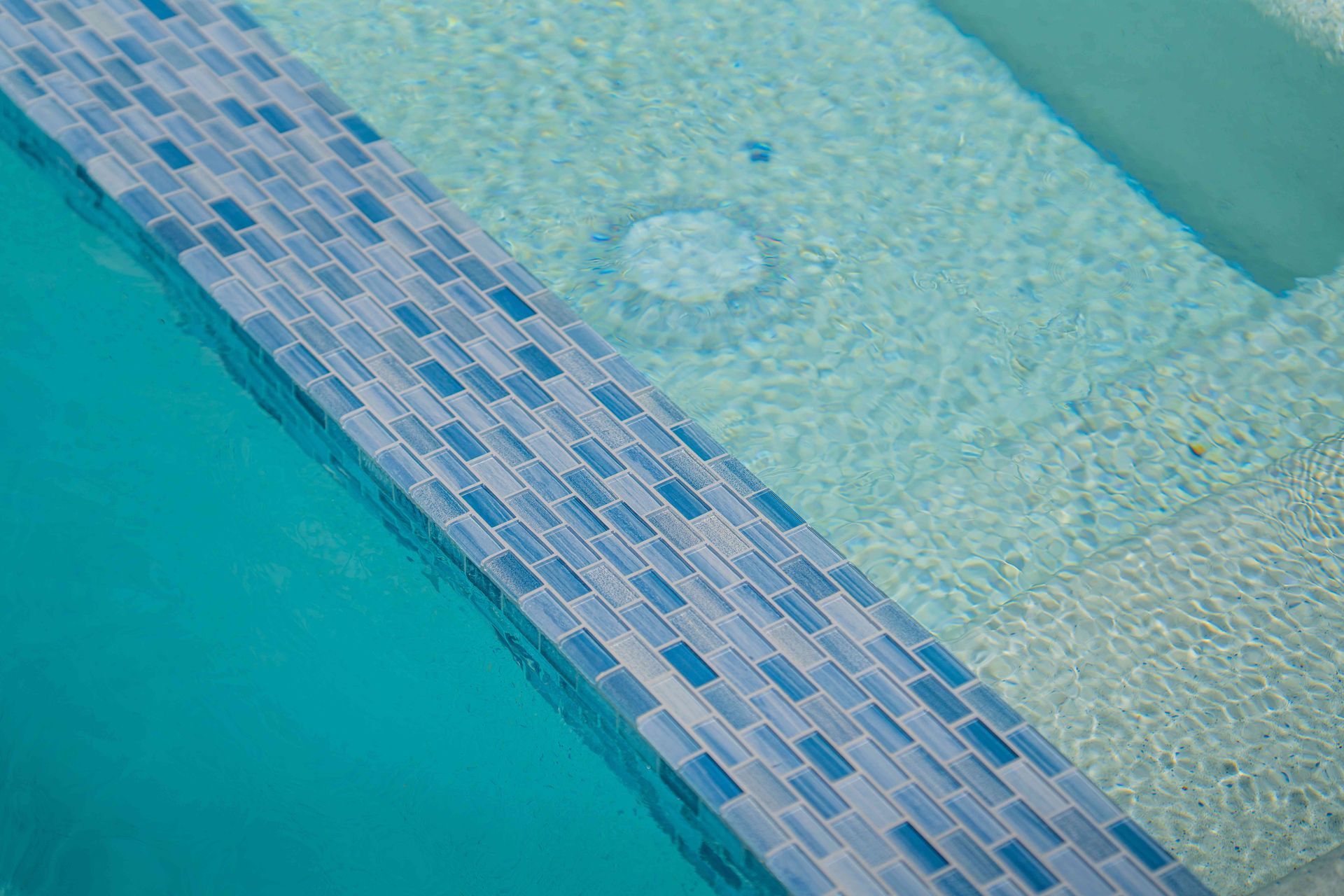 Swimming pool with blue water and a tiled edge divider