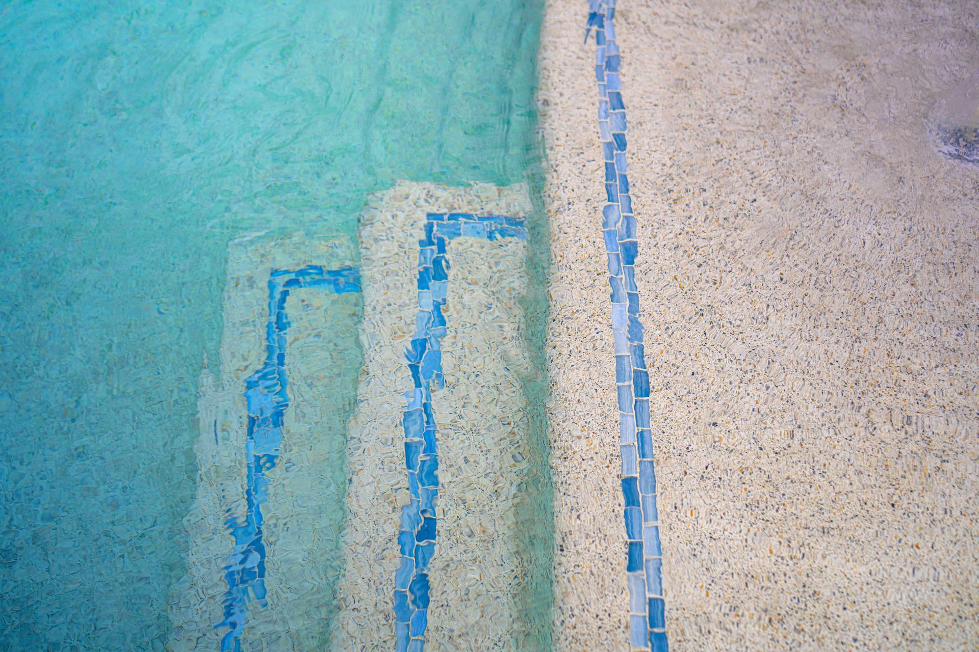 Abstract turquoise and beige wall with blue vertical geometric lines and textured surface
