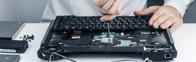 Technician repairing a laptop