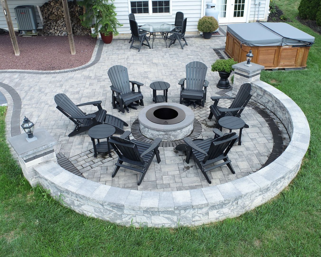 Round firepit on patio surrounded by sitting wall. Nicolock Serafina firepit kit for sale in Lebanon PA.