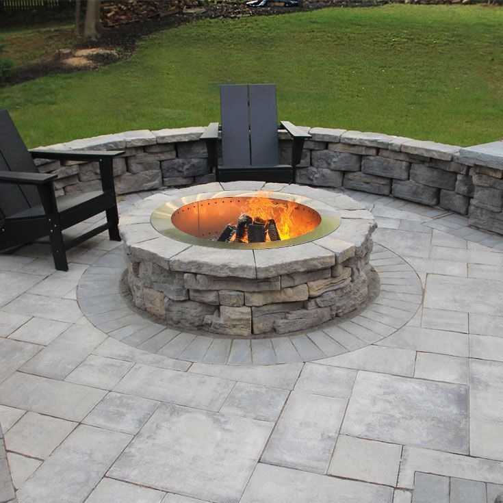 Rustic round firepit on patio surrounded by sitting wall. Nicolock Belvedere firepit kit for sale in Lebanon PA.