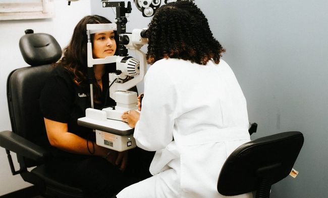 A woman is getting her eyes examined