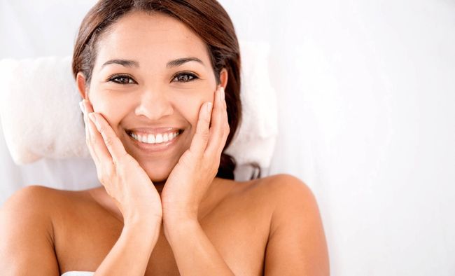 A happy woman after her EMFACE Facial Rejuvenation treatment