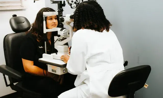 A woman is getting her eyes examined
