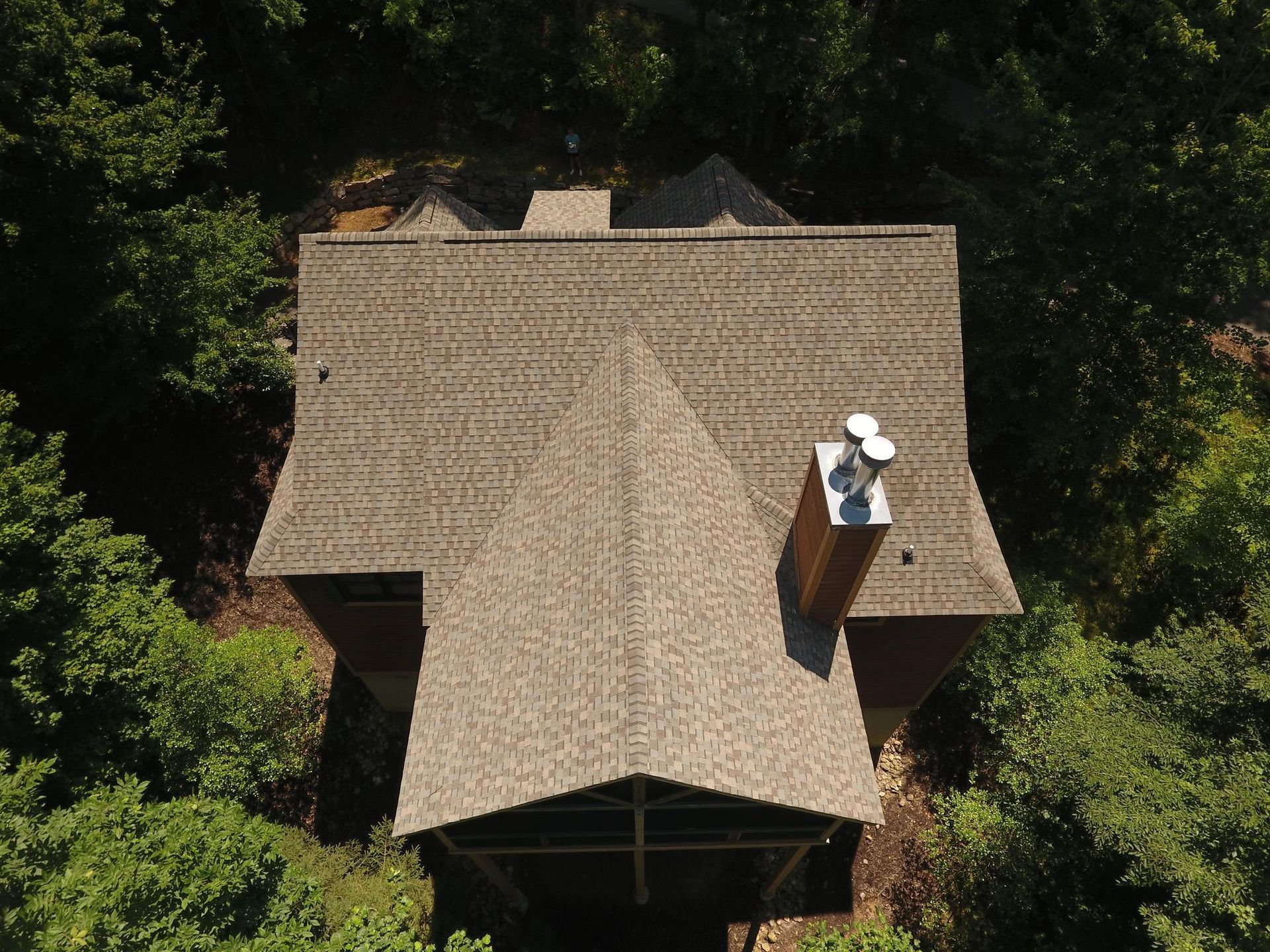 An aerial view of a house with a chimney on the roof