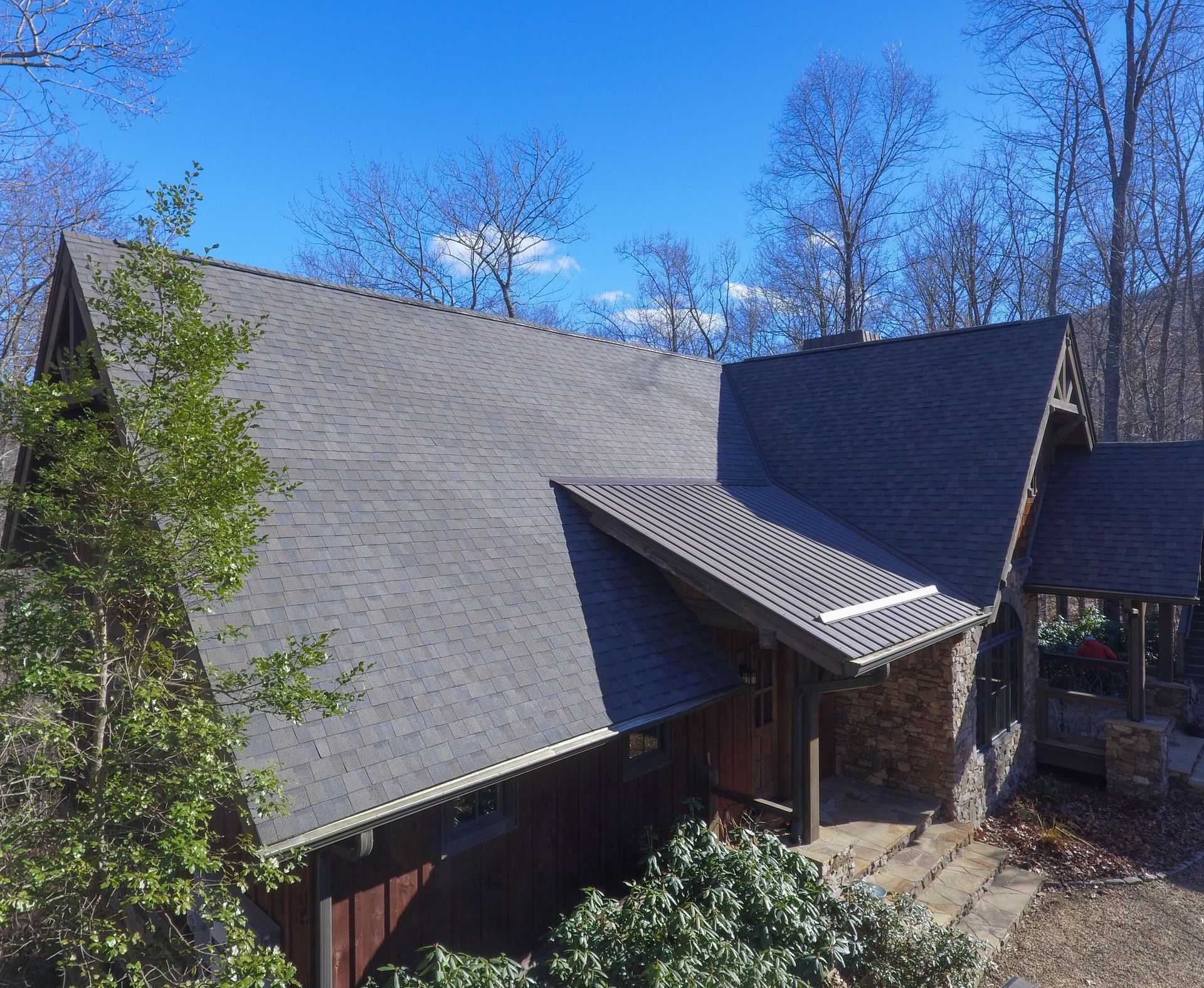 A large house with a roof that is covered in shingles