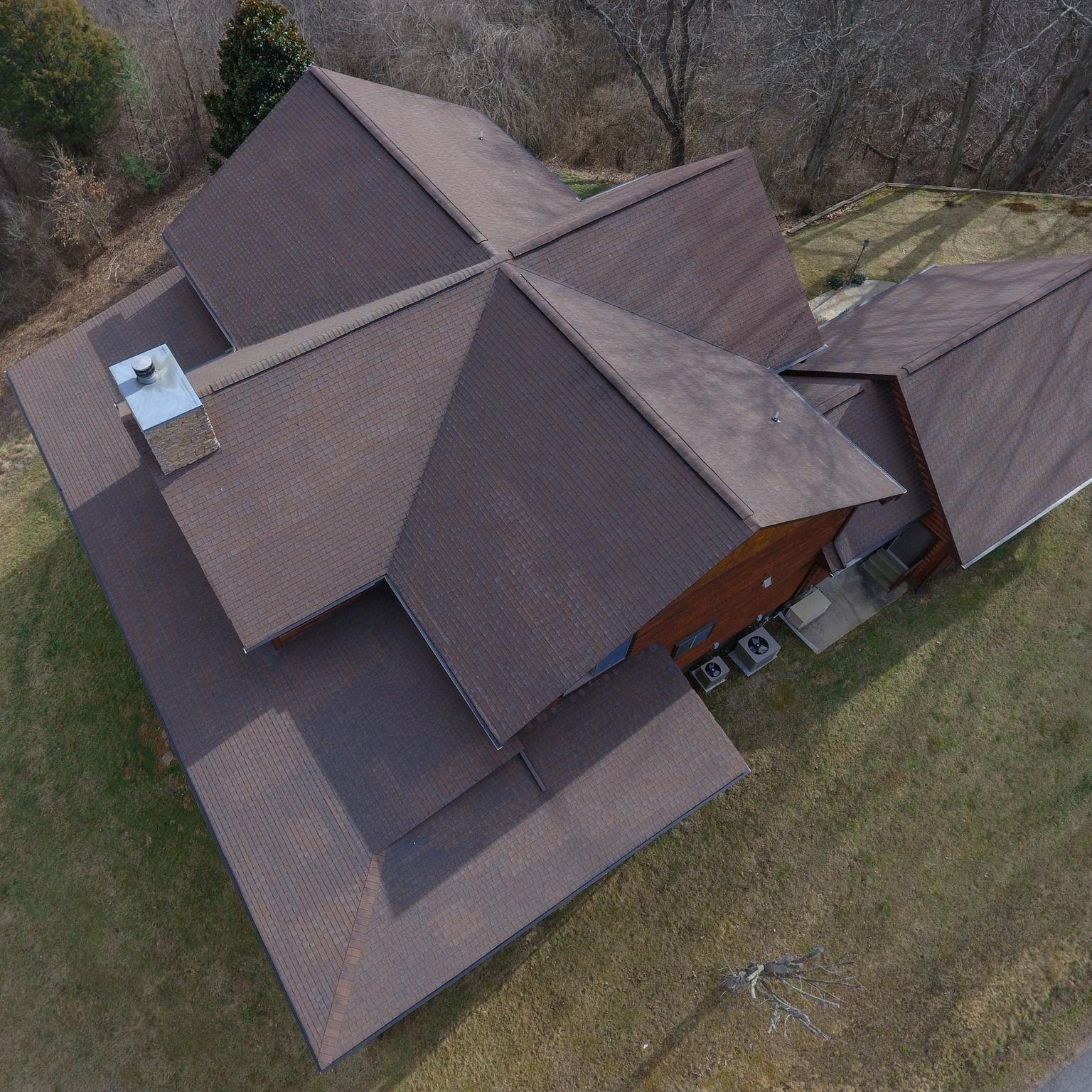 An aerial view of a house with a brown roof